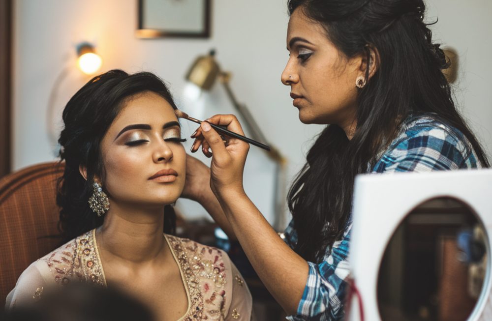 woman-is-applying-makeup-womans-face